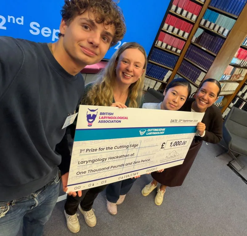 The VoiceWell team holding the hackathon prize cheque.